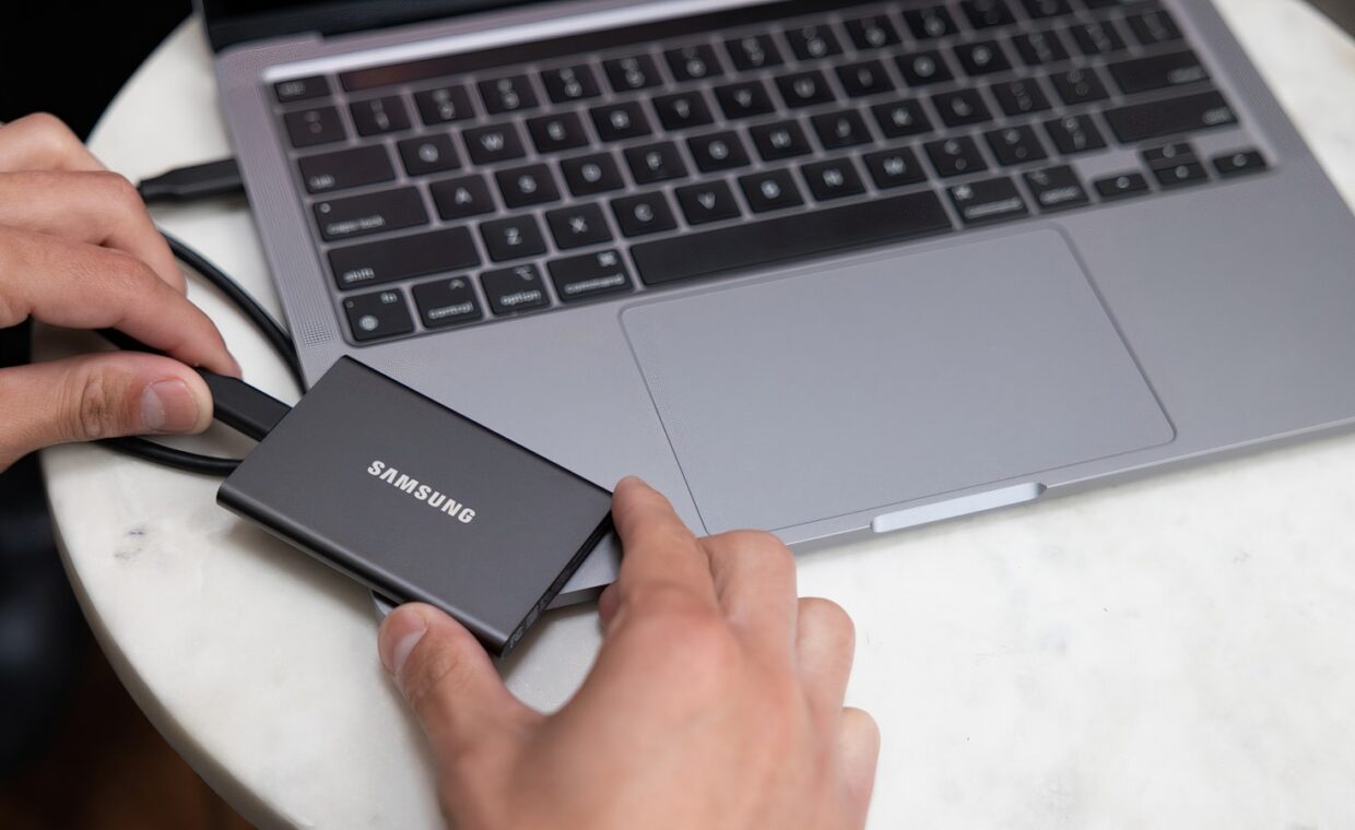 Ssd in hand, photographed for a technology article.
