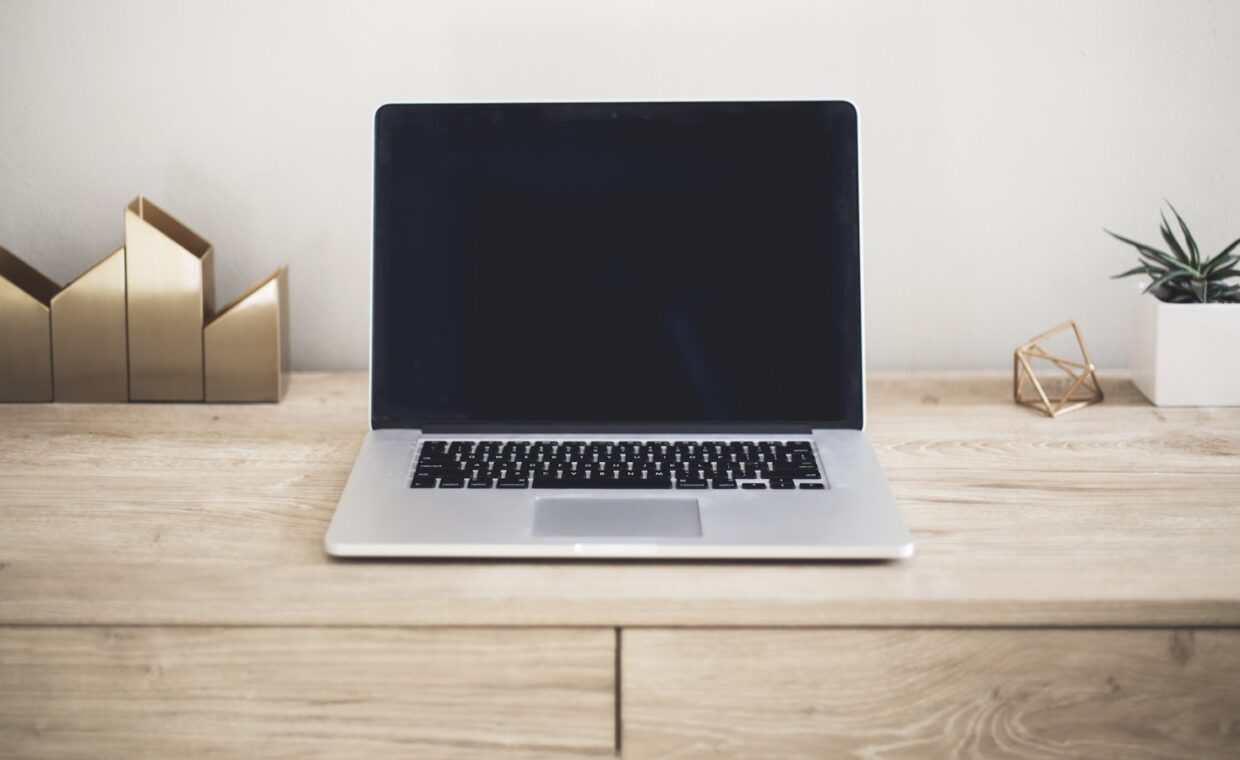 Open laptop desk, photographed for a technology article.