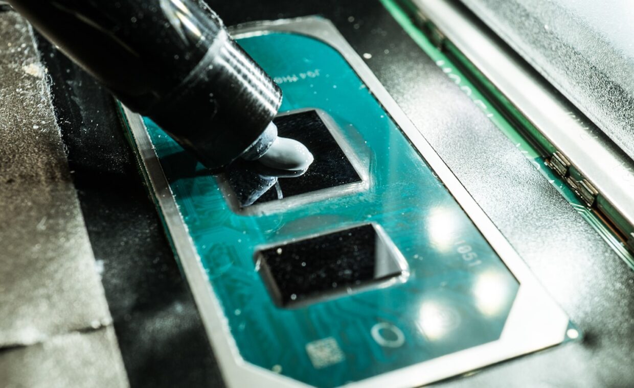 Thermal paste application, photographed for a technology article.