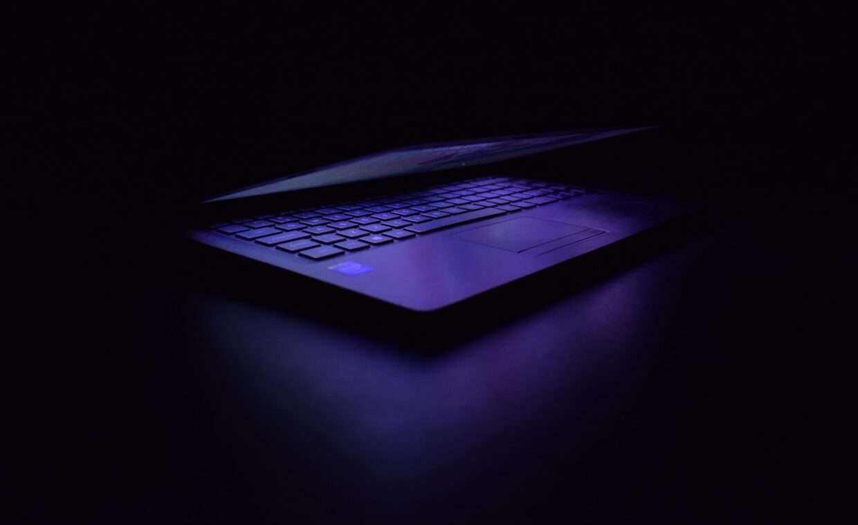 Laptop power button dark, photographed for a technology article.