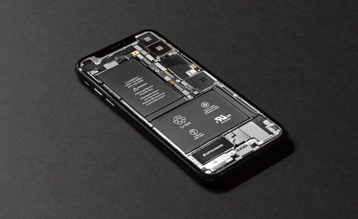 Phone battery swap, photographed for a technology article.