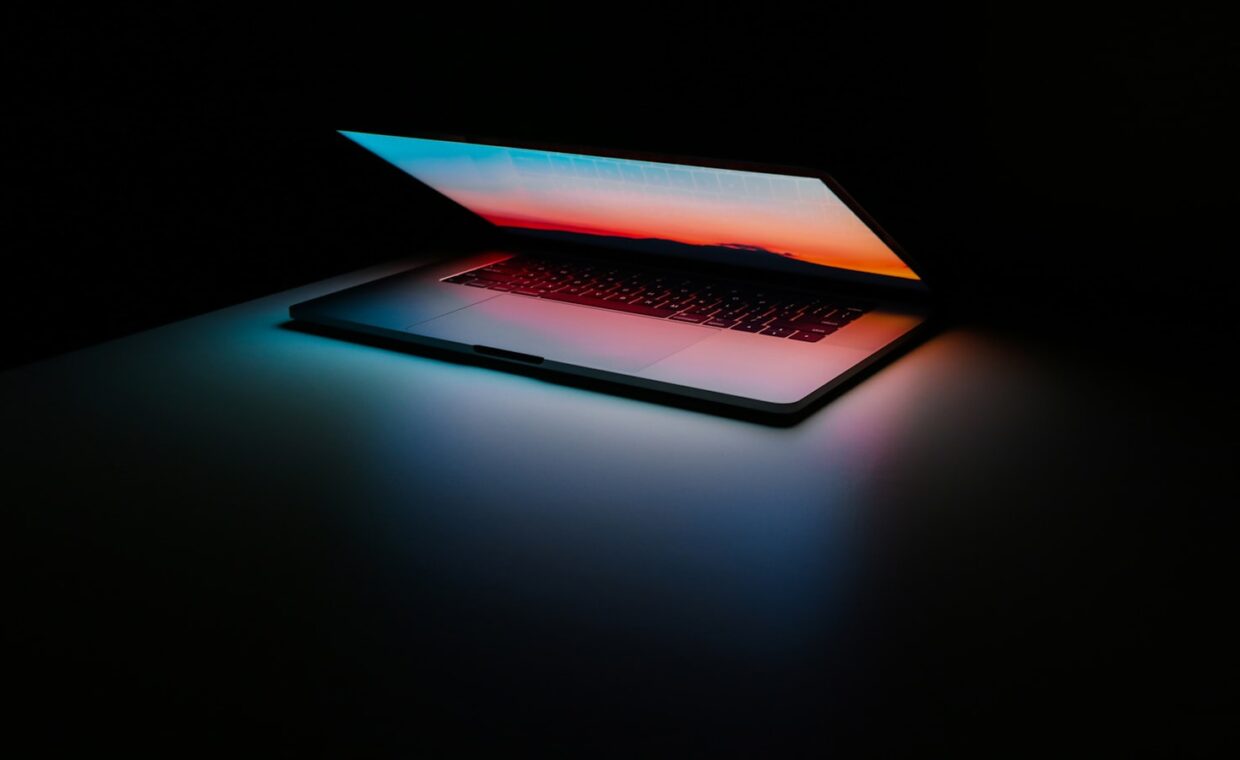 Laptop screen dim room, photographed for a technology article.